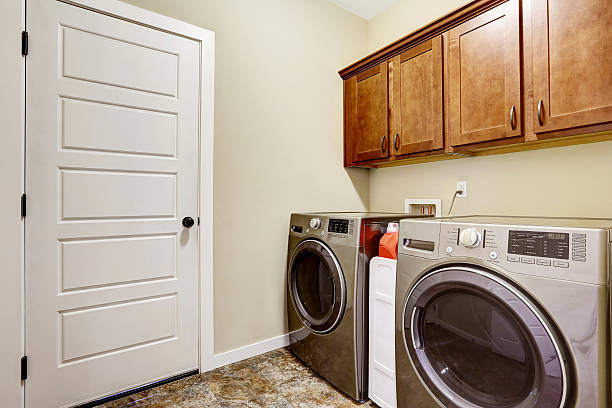 istock Laundry room with steel appliances and nice cabinets 545113078