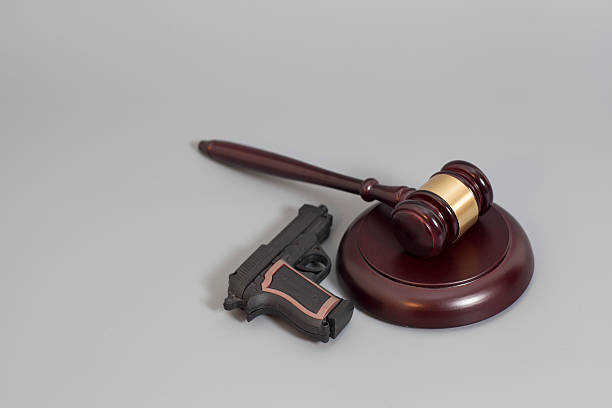 istock judge's gavel and handgun 545113114