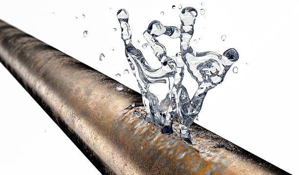 bursted copper pipe with water leaking out stock photo