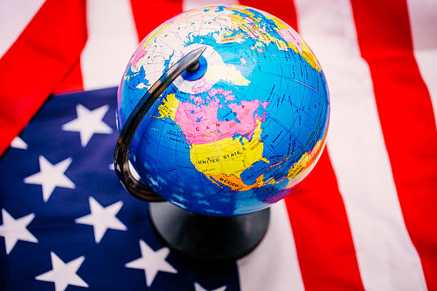 istock US flag with map of the world 545113438