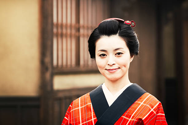 Japanese woman portrait in edo costume and hair style, wearing a red kimono.