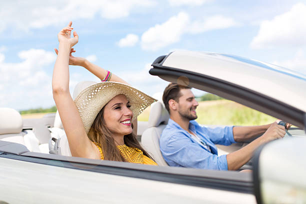 istock Happy young couple driving in a convertible 545114140
