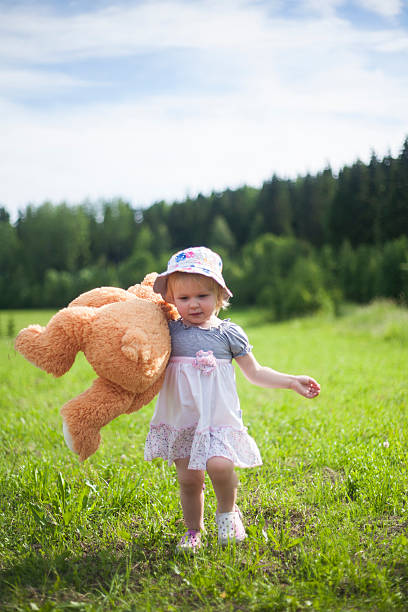 istock Little Girl Carrying Teddy Bear 545114302