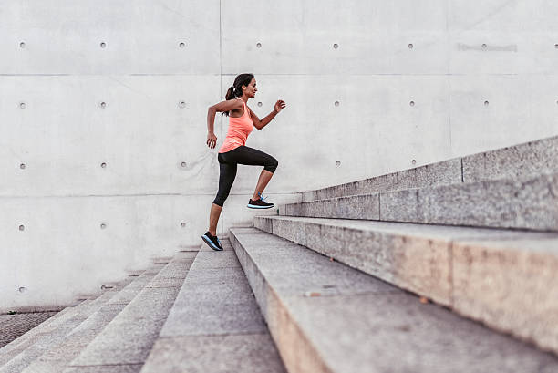 latina sports woman running up outdoor stairway in berlin latina sports woman running up outdoor stairway in berlin steps and staircases stock pictures, royalty-free photos & images