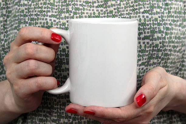 istock Girl is holding white cup in hands. 545114808