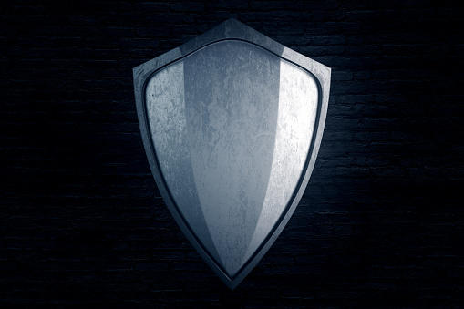 Empty silver shield on black brick background. Mock up, 3D Rendering