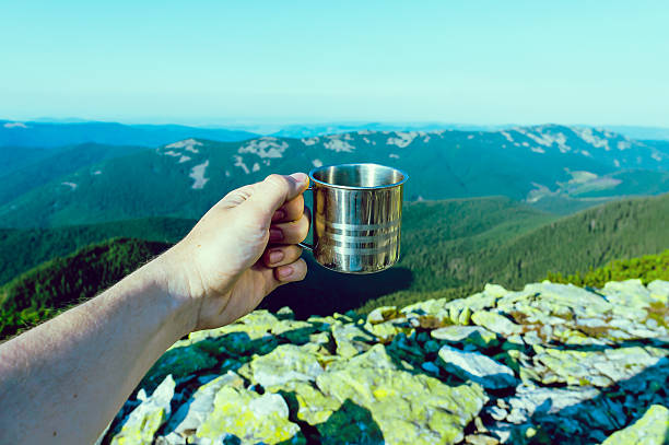 istock Hand of young man holding metallic cup 545115720