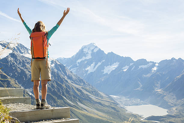 istock Cheering hiker on mountain top celebrates achievement 545117098