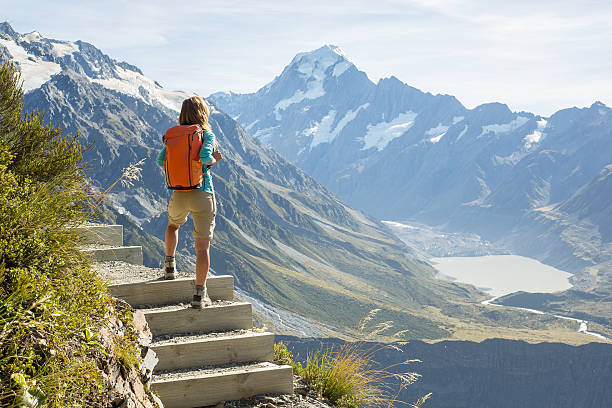 istock Hiker stands on a mountain top and admires view 545117556