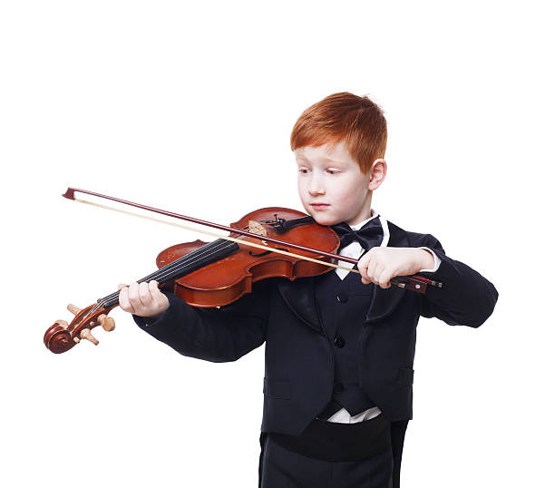 istock Cute redhead child boy plays violin isolated at white background 545117706