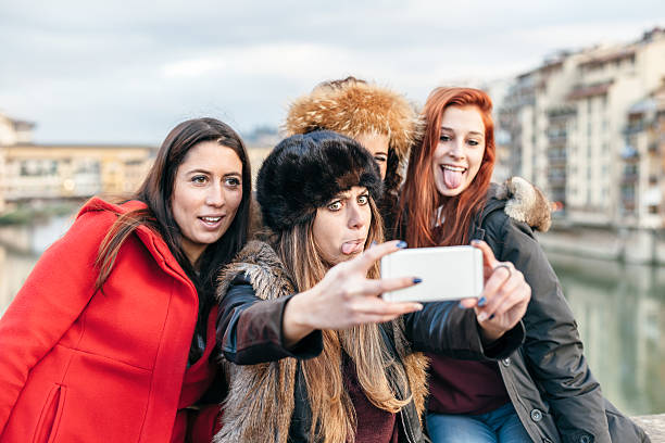 istock Four female friends taking selfie on a bridge in Florence 545117750