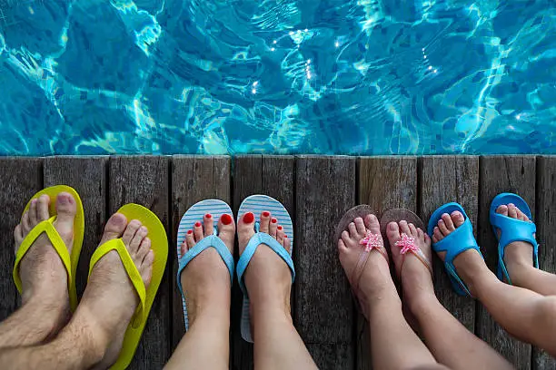 Photo of Family wearing brightly colored flip-flops