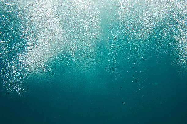istock Sea wash bubbles rising in dark water 545121214