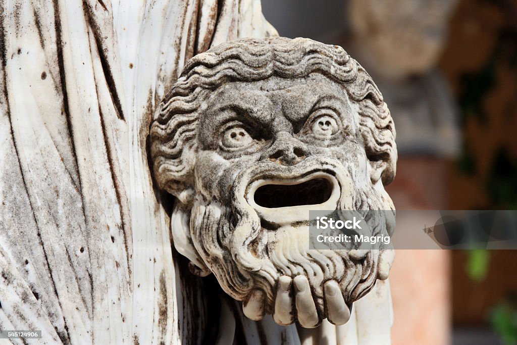 Tragic mask in hand of greek statue of Melpomene A tragic mask in the hand of Statue of Melpomene, the muse of tragedy, on the balcony of Achillion princess Sissy's palace on greek island Corfu in Greece. Greece Stock Photo