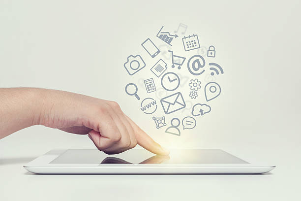 istock woman touching tablet computer screen and media icons fly 545125728
