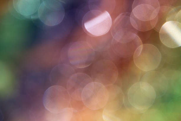 istock Glare in blurring circles, sunbeams defocused bokeh. Multicolored - red 545125920