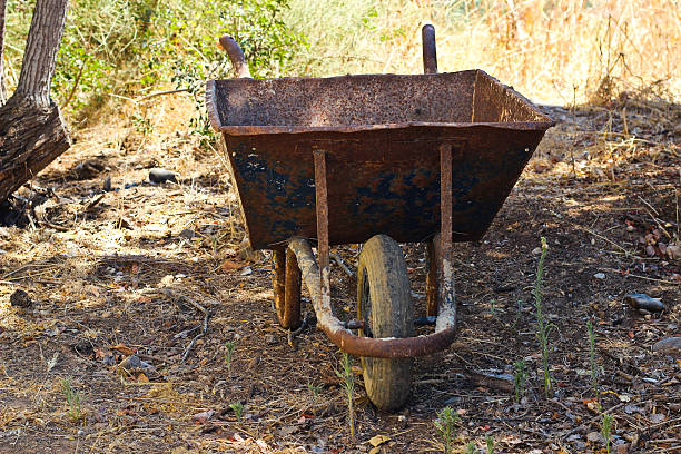 Rusted wheelbarrow stock photo