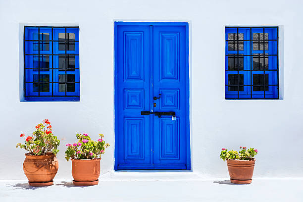 traditional white church with blue doors in santorini, greece - santorini door sea gate bildbanksfoton och bilder