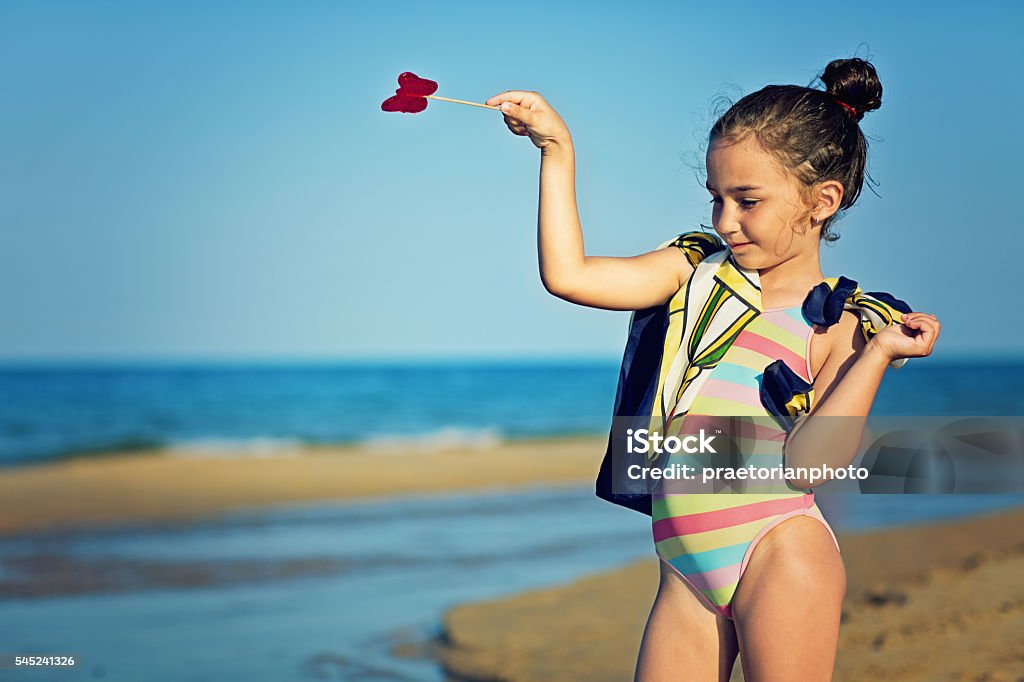 On the beach Small girl is standing on the beach and dreaming. Baby - Human Age Stock Photo