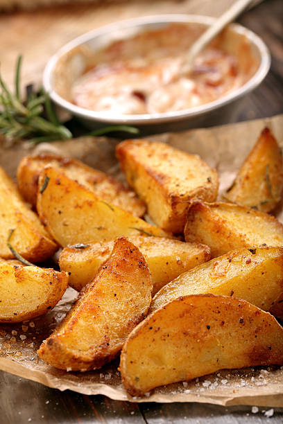 istock Roasted potatoes with dip on wooden table 545241364