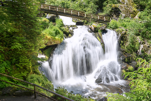 Triberg Waterfall with wooden bridge in the sunny summer. Taken in Triberg in the Black Forest, Germany.