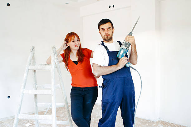 istock Young couple makes repairs in home together. 545242036