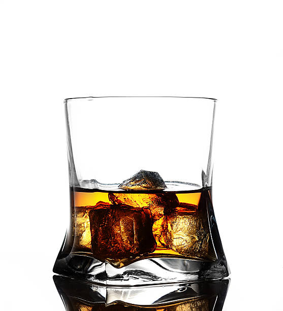 istock Glass of scotch whiskey and ice on a white background 545243152
