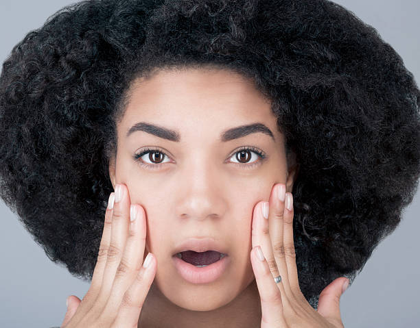 istock Surprised young black woman looking at the camera 545243426