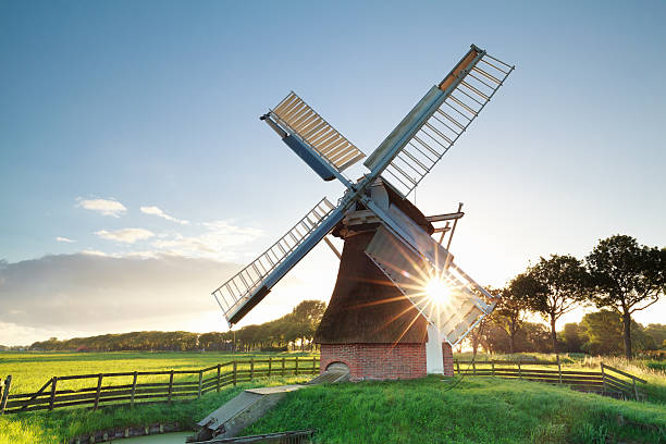 istock morning summer sunshine behind Dutch windmill 545243504