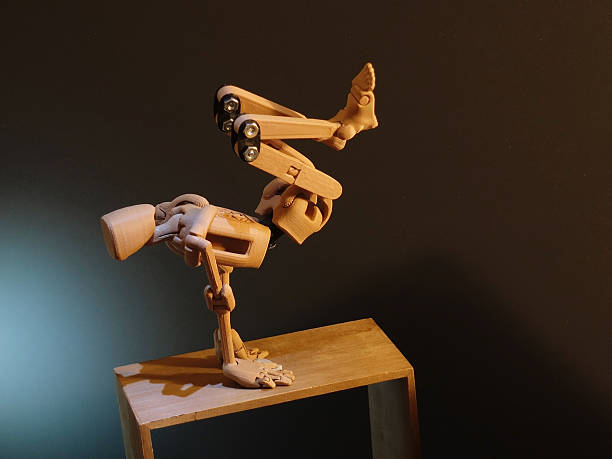 Wooden doll (or armature) standing on its hands.