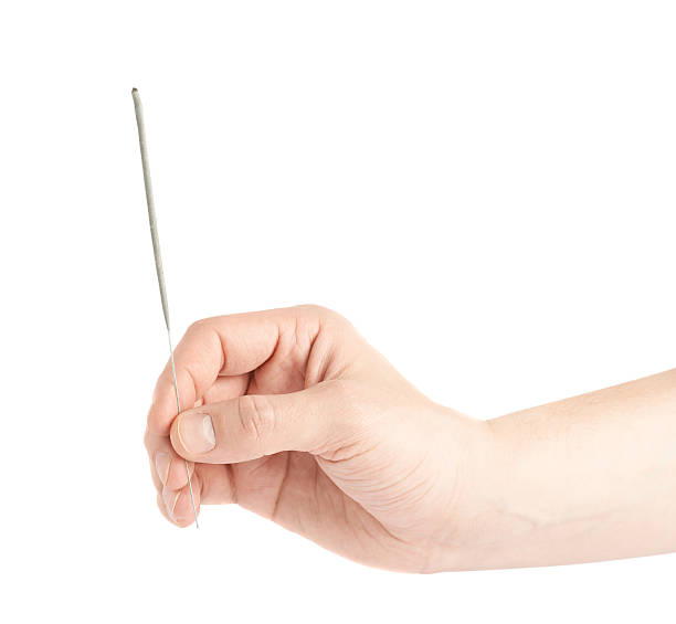 istock Male hand holding a sparkler isolated 545245982