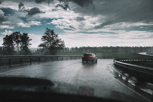Drive car in rain on curve asphalt wet road