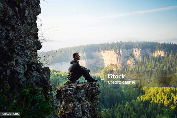 Man Sitting On The Top Of The Mountain Leisure In Stock Photo - Download Image Now - Meditating, Mindfulness, Nature