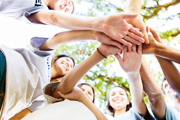istock Happy volunteers putting their hands together in a powwow 545247192