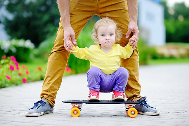 istock Cute toddler girl learning to skateboard 545247828