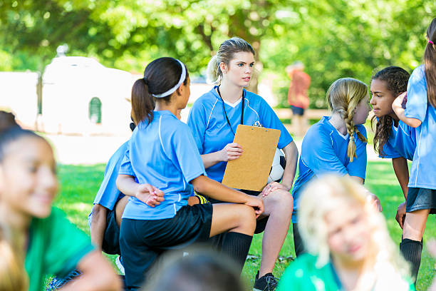 istock Girls soccer coach huddling with team 545248134