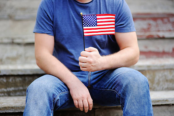 Handsome man holding american flag Handsome man holding american flag. Independence Day concept. patriotic man stock pictures, royalty-free photos & images