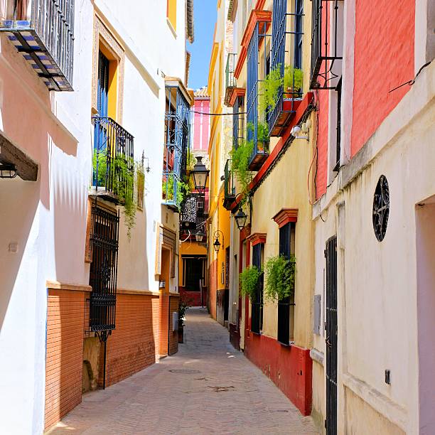 strada colorata nel centro storico di siviglia, spagna - seville spanish culture spain town square foto e immagini stock