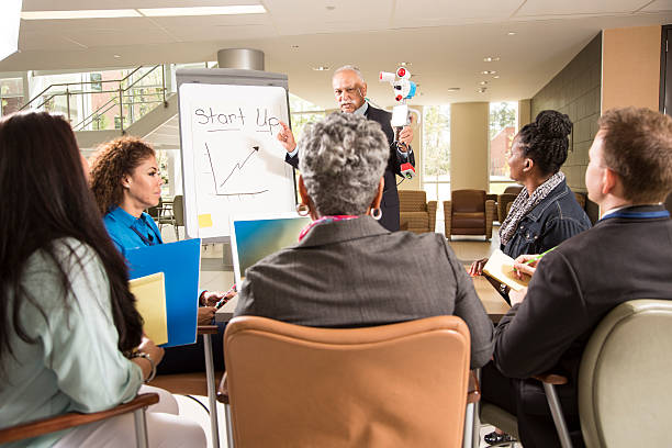 istock New business start-up. Man demonstrates invention, robot prototype. 545251418
