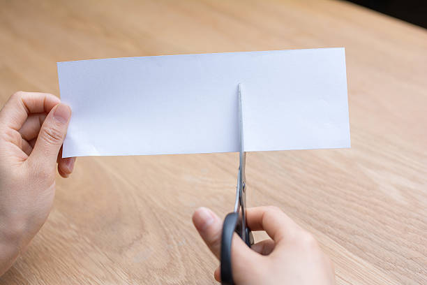 istock woman cutting white paper 545252412