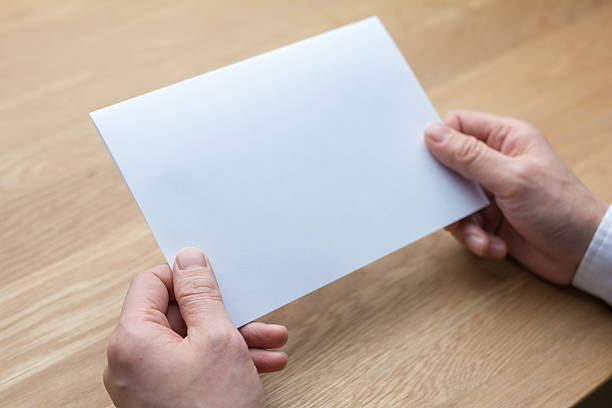 istock businessman holding white blank paper 545252680