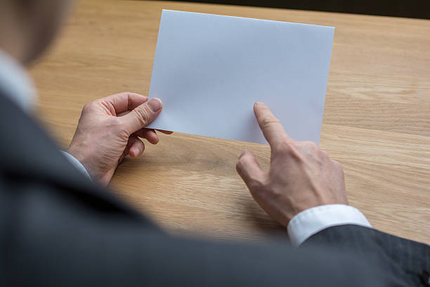 istock businessman holding white blank paper 545252736