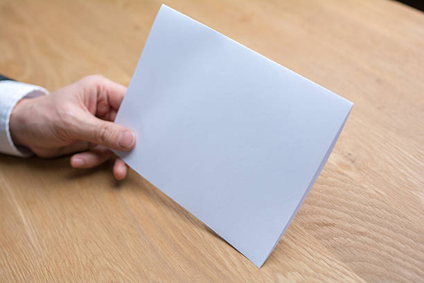 istock businessman holding white blank paper 545252802