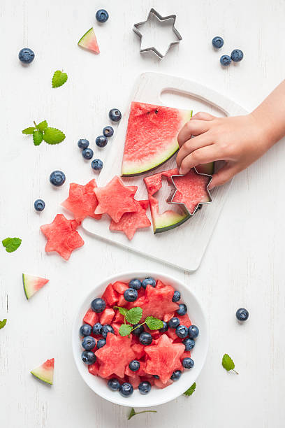 istock children's hands cooking salad on white table, flat lay 545252816