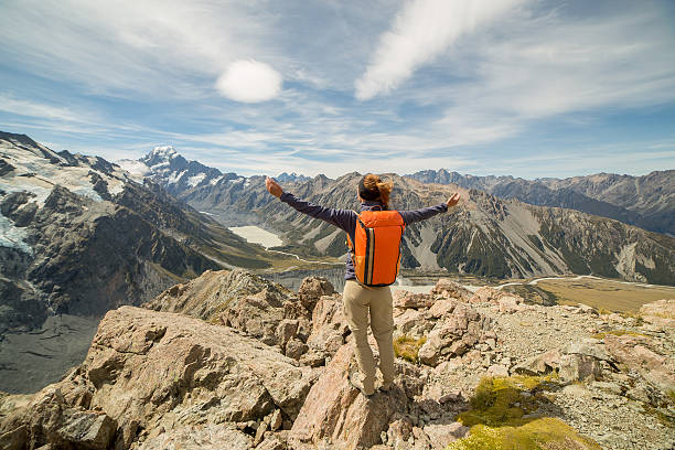 istock Hiker stands on a mountain top arms outstretched for freedom 545253126