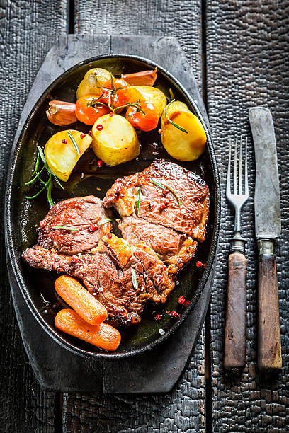 istock Roasted steak and vegetables with fresh herbs on barbecue 545253372