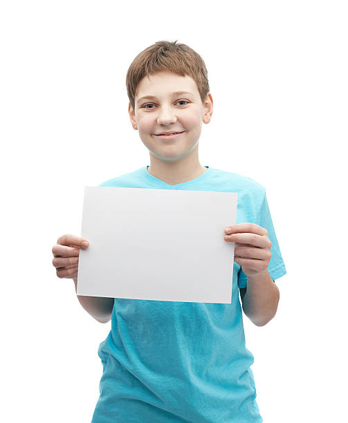 istock Happy smiling young boy with a sheet of paper 545253420