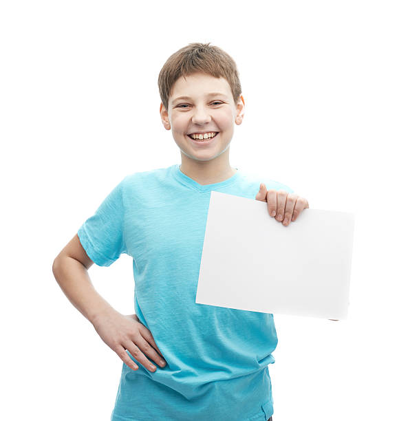 istock Happy smiling young boy with a sheet of paper 545253474