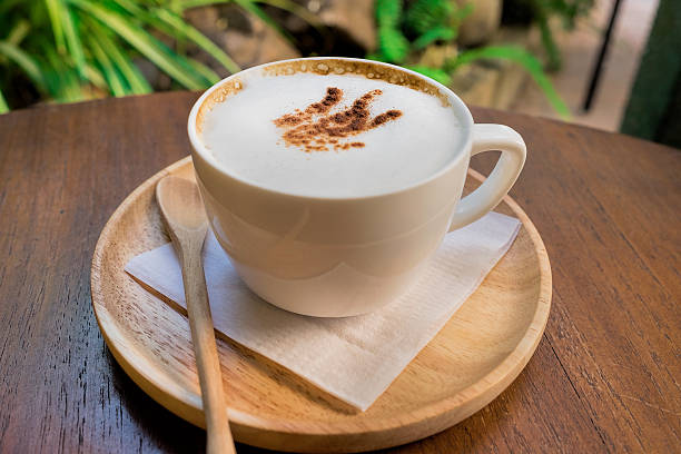 istock coffee cup on wooden table on brown background 545253940