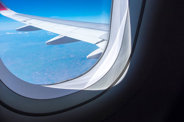 istock Close up Airplane window with airplane wing 545254584